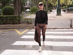 Naughty Lada wearing seamless pantyhose takes off her skirt in public place